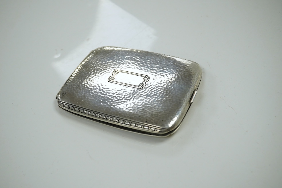 A George V silver and tortoiseshell trinket box, 6.5cm, a planished sterling cigarette case, an early silver wrist watch and sundries. Condition - fair.